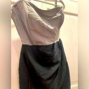 Corseted, black and gray fitting strapless dress.